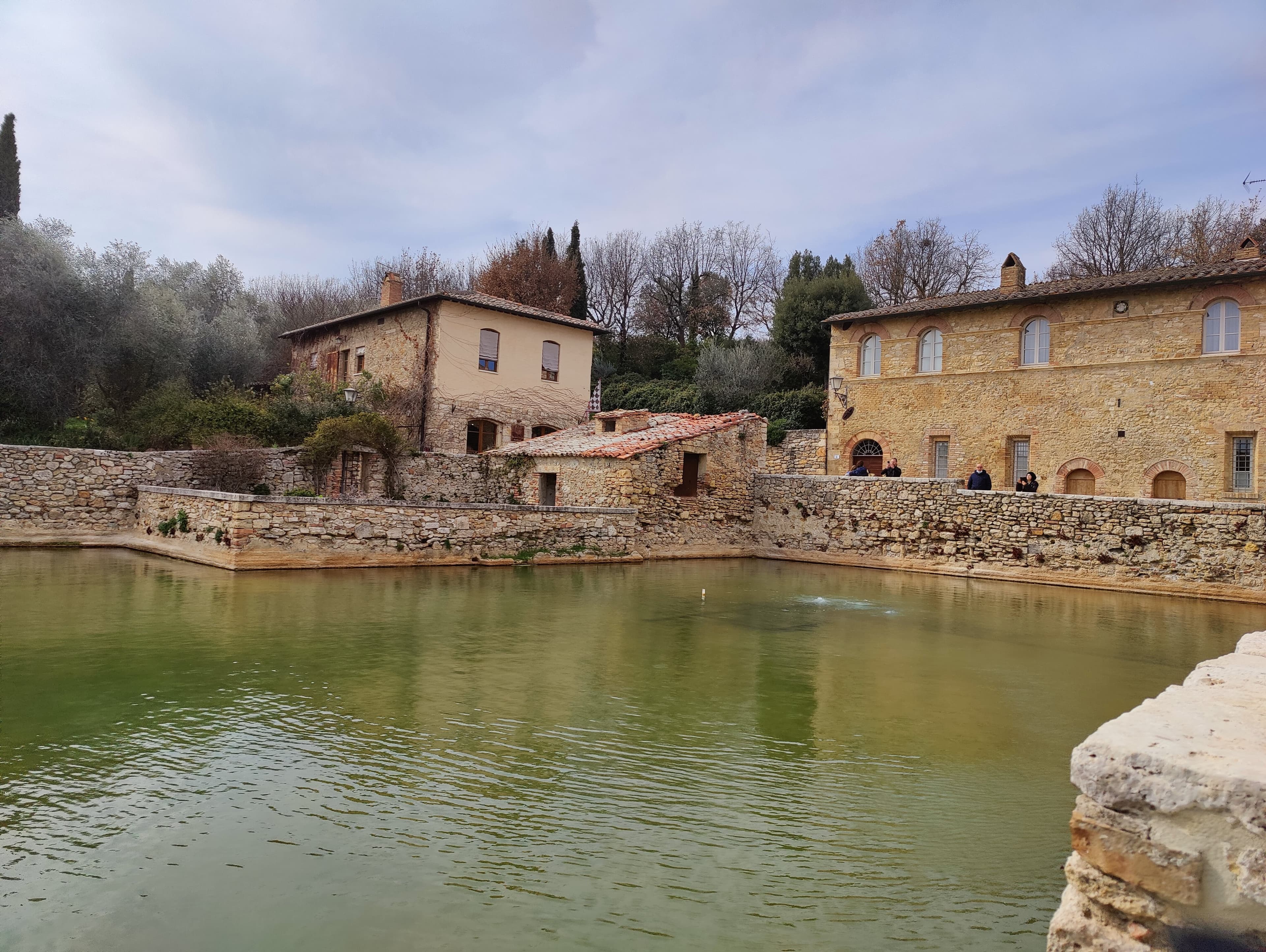 Bagno Vignoni thermal pool — steam at dawn