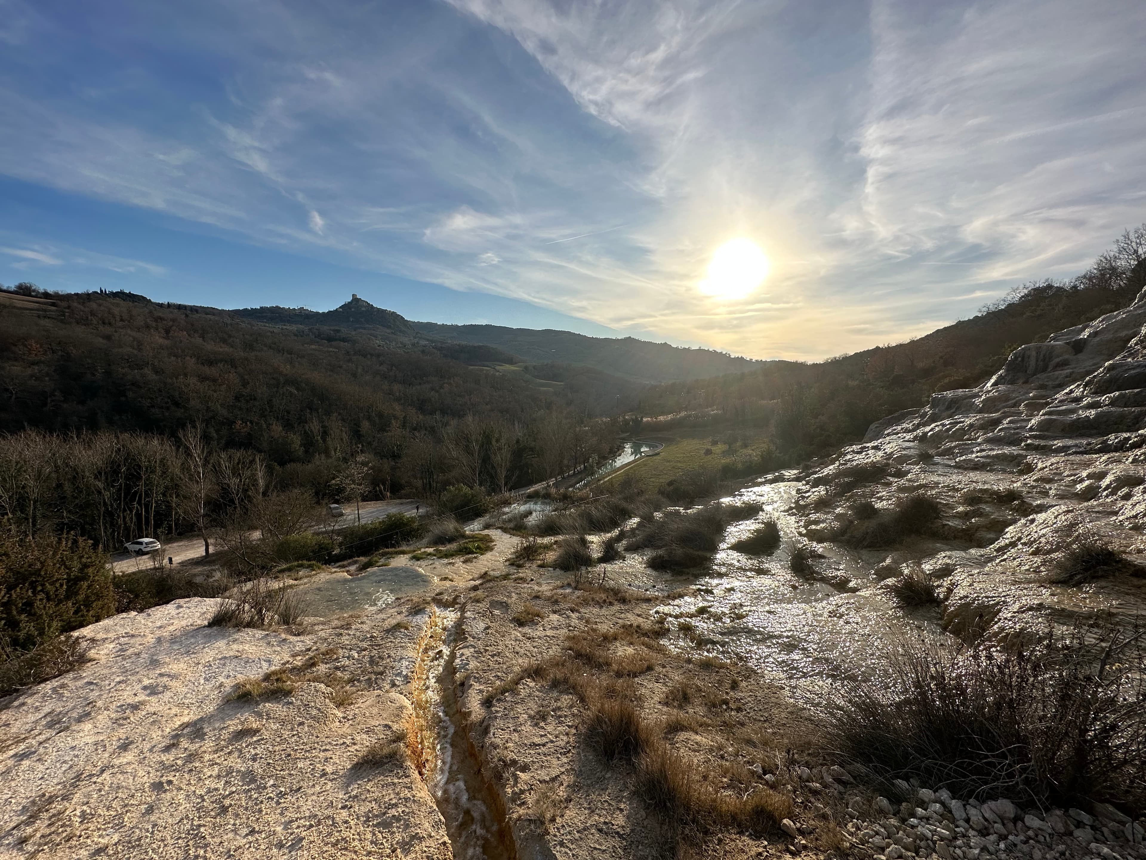 View from Fosso Bianco toward the Amiata mountains — white travertine terraces